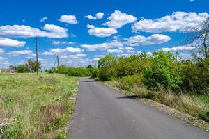 Beautiful empty asphalt road in countryside on colored background photo