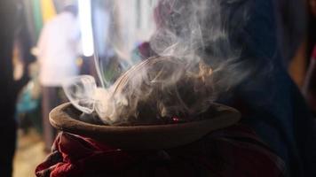 tradicional hindu dhunuchi cenas com uma muitos do fumaça. piedosos adoração elementos vídeo dentro hindu religião. argila Panela com coco casca e fumaça. hindu puja elementos e dhunuchi fechar-se imagens de vídeo. video