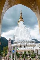 The cloudy sky and white five buddhas statue at Phra Thad Pha Son Kaew Temple. Khao-kho, Phetchaboon Distict, Thailand photo