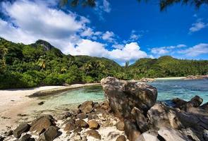 Port glaud beach, Beach, rock boulders and mountain, Mahe Seychelles photo