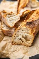 baguette long white bread whole wheat flour, wheat bread, sourdough meal food snack on the table copy space food background rustic top view photo