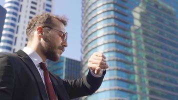 Businessman talking on the phone. Businessman talking on the phone in image with residences in the background. video