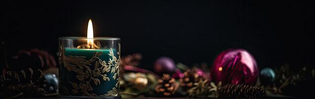 Burning candle and Christmas decoration over snow and wooden background. . photo