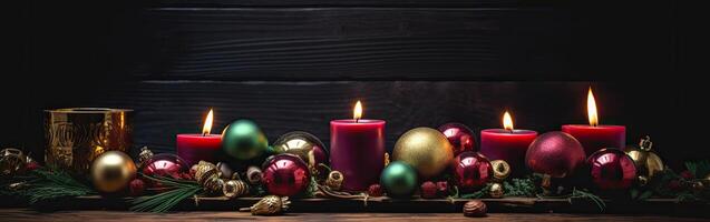 Burning candle and Christmas decoration over snow and wooden background. . photo