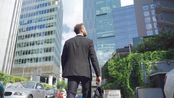 Businessman on Streets of Business District. Businessman walking through the area of business offices. video