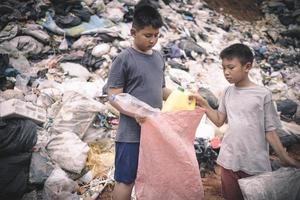 Poor children collect garbage for sale because of poverty, Junk recycle, Child labor, Poverty concept, human trafficking, World Environment Day, photo