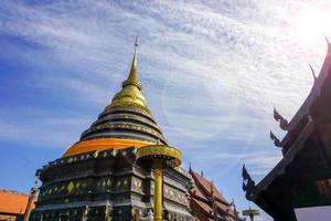 The enormous pagoda and golden Buddhist temple of Lanna art in Wat Phra That Lampang Luang is precious with ancient stucco art dating back over 1300 years. photo