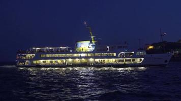 Ferry and passengers on the sea at night. The ferry sails at night on the sea. There are passengers inside. video