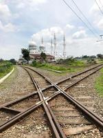 Surakarta, Indonesia, January 2023. Railway infrastructure and beautifully isolated sheikh zayid mosque photo
