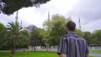 Young tourist man travels. The young man who visits historical places is happy. video