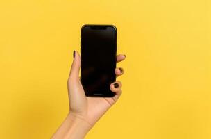 Hand with empty mockup phone on vivid background. Illustration photo