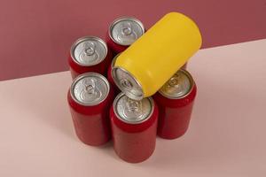 Cold red soda cans with a yellow one for conceptual use photo