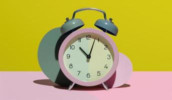 Alarm clock on a pink and yellow background. 3d illustration photo