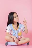 Image of Asian child posing on Pink background photo