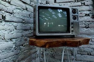 Retro old orange TV receiver on table photo