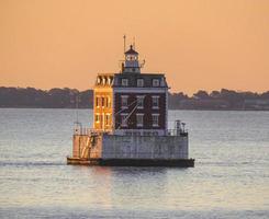 New England Red brick lighthouse in harbor photo
