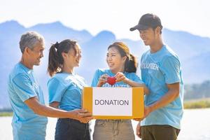 Group of volunteer people joining together in money raising event for donation in charity work and ngo related activity such as global warming, environmental issues, pollution and eco-friendly project photo
