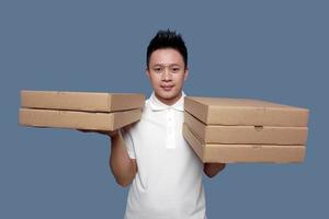 Man holding cardboard box in both hands isolated on plain background. photo