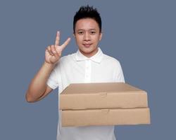 Man holding cardboard box with two finger hand gesture. photo