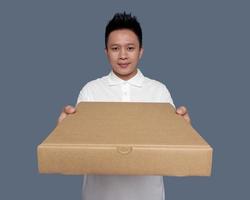 Man holding and giving cardboard box in front view. photo