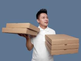 Man holding cardboard box in both hands looking up photo