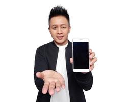 Handsome man showing and presenting smart phone with open palm. photo