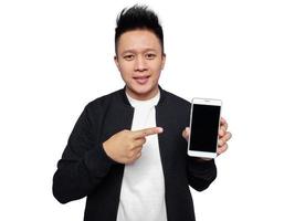 Handsome man holding and pointing at smartphone screen with smile facial expression photo