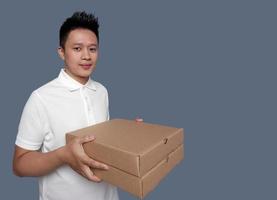 Man holding brown cardboard box isolated on plain background photo