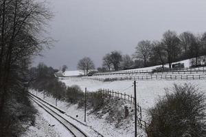 Railroad and Road above in Winter Snow photo