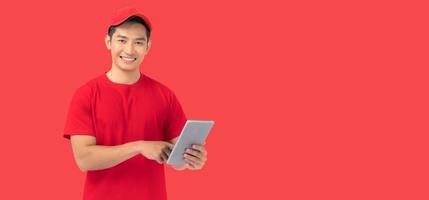 Online shopping, delivery, technology and lifestyle concept, Smiling delivery man holding a tablet in his hand. photo