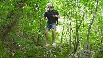 The free man is on a jungle journey. Young man is traveling in the green forest. video