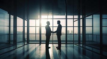 silhouettes two businessmen handshake in cooperation agreement concept at office and successful business partner. business man shaking hands to seal a deal with his partner. . photo