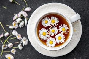 tea chamomile flowers healing hot drink healthy meal food snack on the table copy space food background rustic top view photo