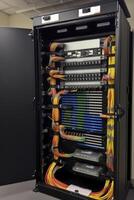 Ethernet cables and path panel in rack cabinet. photo