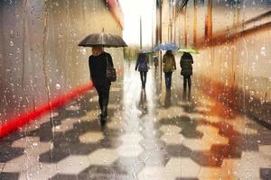 Bilbao, Vizcaya, Spain, 2023 - people with an umbrella in rainy days in winter season, bilbao, basque country, spain photo