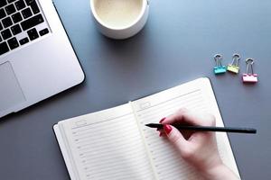 Hand writing in a diary top view photo