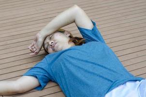 Young Asian woman fainting putting her hands on her forehead because of hot weather photo