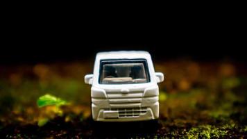South Minahasa, Indonesia  January 2023, a toy car on a mossy floor that looks like grass photo