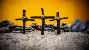 crosses stuck in the sand on an orange background photo