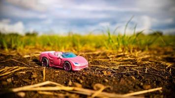 South Minahasa, Indonesia  February 2023, toy car on green grass photo