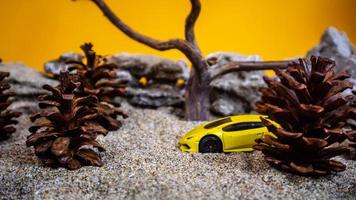 Minahasa, Indonesia  saturday, December 2022, a toy car among the pinecones photo