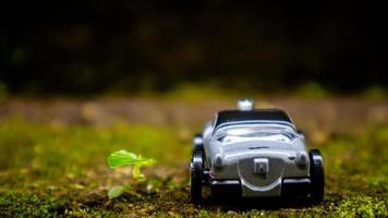 South Minahasa, Indonesia  January 2023, a toy car on a mossy floor that looks like grass photo