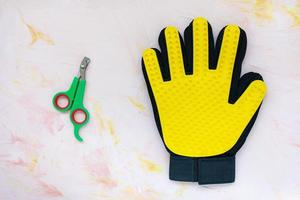 Glove and nail clippers for cats and dogs grooming photo