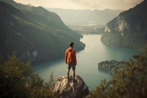 Man standing on the cliff and looking at landscape, created with photo