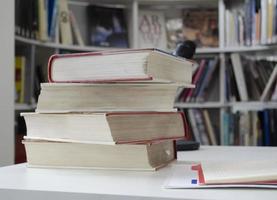 Old dirty books on the table. Books blurred background. photo