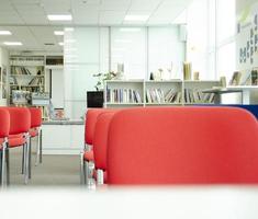 Before a conference. Empty conference meeting space. Red chairs and books on the background. photo