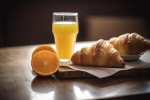 Orange juice and croissant breakfast. photo