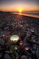 bunch of rocks on a beach with a sunset in the background. . photo