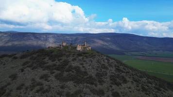 Aerial zoom orbiting view of castle ruins Turna video