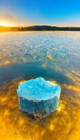 piece of ice sitting in the middle of a lake. . photo